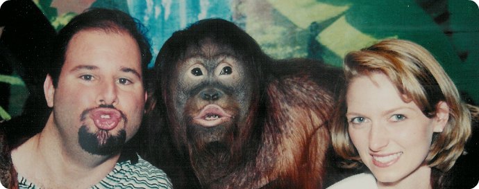 My wife and I with an orangutan
